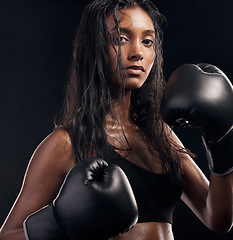 Image showing Boxer, gloves and portrait of woman on black background for sports, strong focus or mma training. Female boxing, workout or fist fight of impact, energy and warrior power for studio fitness challenge