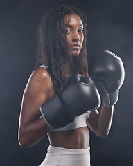 Image showing Boxer gloves, woman and portrait on black background for sports, strong focus or mma training. Female boxing, champion and fist fight in studio, impact and warrior energy for power of fitness workout