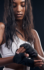 Image showing Boxer, gloves and sweat with a sports woman getting ready in studio on a black background for fitness. Exercise, health and training with a female boxing athlete sweating during a combat workout