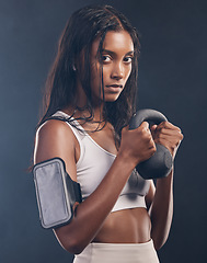 Image showing Woman, kettlebell and portrait of exercise in studio for fitness, sports workout or serious mindset. Face of strong female, bodybuilder and weights for training with armband, energy and on background