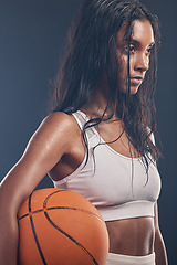 Image showing Basketball player, sports workout and studio woman for wellness challenge, practice game or fitness competition. Performance training, health exercise and athlete model isolated on dark background