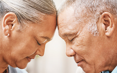 Image showing Face, love and support with a senior couple in their home, touching heads in trust or solidarity together. Relax, peace or romance with a mature man and woman bonding in their house during retirement