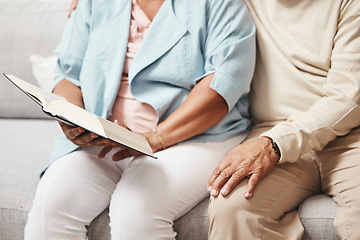 Image showing Hands, bible and praying with an old couple reading a book together in the home during retirement. Jesus, faith or belief with a senior man and woman in prayer to god in a house for spiritual bonding