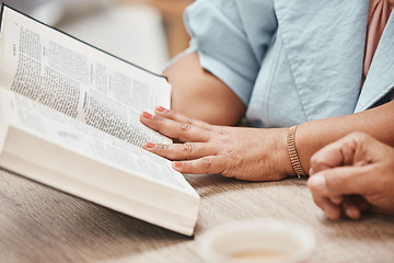 Image showing Hands, bible and reading with a senior couple studying a book together in their home during retirement. Jesus, faith or belief with a man and woman praying to god in their house for spiritual bonding