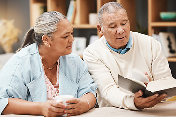 Image showing Book, reading and senior couple with bible for spiritual studying, faith and relax in home with coffee. Religion, tea and retired man and woman with holy text for learning, education or worship God.