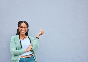 Image showing Mockup, portrait and black woman pointing to space for advertising, empty or grey wall background. Face, gesture and girl relax, happy and smile in studio on product placement, isolated or copy space