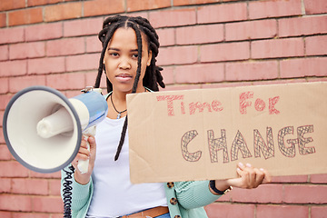 Image showing Poster, portrait and woman on megaphone for change, protest or human rights on brick wall background. Banner, speaker and face of girl for announcement of global, transformation or freedom mission