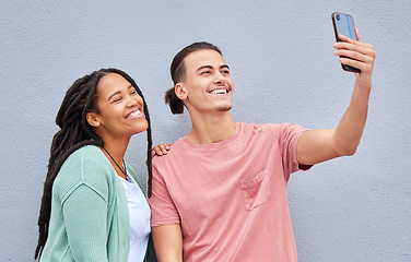 Image showing Love, friends and selfie with smile, casual and wall with freedom, trendy and loving together. Black woman, man and smartphone for picture, share post and social media on studio background and happy