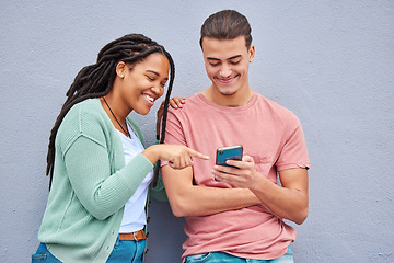 Image showing Man, woman and phone by wall for meme, social media or blog post with happiness together in city. Interracial couple, smartphone and happy with smile, comic and funny video on internet app in metro