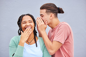 Image showing Love, secret and man whisper to his girlfriend a funny story, joke or information by a wall in city. Comic, laughing and guy talking in woman ear for gossip while in town on holiday or weekend trip.