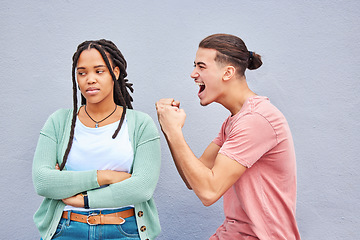 Image showing Winner, competition and success with a man celebrating after winning a bet against his loser girlfriend on gray background. Success, wow or victory with a boyfriend cheering a win against a woman