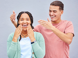 Image showing Wow, surprise or love and a couple on a gray background outdoor with a man covering the eyes of his girlfriend. Diversity, hands or dating with a woman being surprised by her boyfriend against a wall