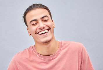 Image showing Man, face or laughing on isolated background at funny joke, meme or comedy on grey mockup, model wall or mock up backdrop. Smile, happy or comic student in fashion, trendy style or cool relax clothes