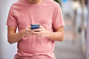 Image showing Man, hands or phone typing on city street, road or urban location on social media app, dating website or internet networking. Student, person or model on mobile communication technology for gps maps