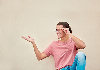 Image showing Mockup, hands and happy man pointing to space for advertising, empty and grey wall background. Hand, gesture and guy relax, content and smile in studio for product placement, marketing and copy space