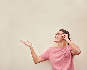 Image showing Hands, mockup and happy man pointing to space for advertising, empty and studio background. Smile, hand gesture and guy relax, content and showing wall for product placement, marketing and copy space