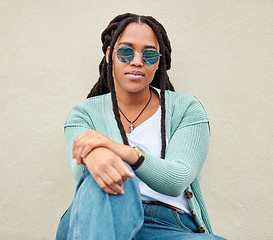 Image showing Black woman, sunglasses and portrait by wall background in city with fashion, summer and beauty. Young gen z, african student girl and outdoor for travel, urban adventure and aesthetic with clothes