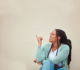 Image showing Black woman, happy and hands pointing to mockup, advertising or empty background, laugh and excited. Hand gesture, smile and girl relax in studio while showing wall copy space for isolated marketing