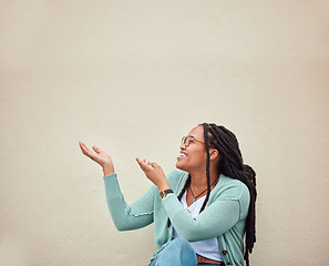 Image showing Happy, black woman and hands pointing to mockup, advertising or empty background, laugh and excited. Hand gesture, smile and girl relax in studio while showing wall copy space for isolated marketing