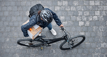 Image showing Delivery, package and man with a bicycle and box in the street for consumer order in the city. Transport, courier and male bike driver with stock with eco friendly transportation in the road in town.