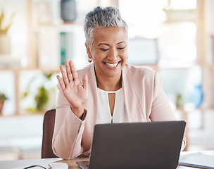 Image showing Video call, online and senior business woman waving greeting on internet, website or web conference from her office. Elderly, corporate and professional or executive employee using laptop for meeting