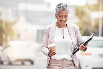 Image showing Corporate senior woman, city and walk with coffee, folder and excited for financial service career. Accountant, happiness and smile by blurred background in metro, street or motivation for accounting