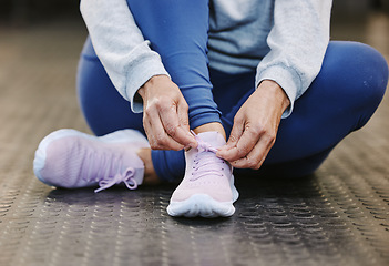 Image showing Hands, fitness and tie shoes in gym to start workout, training or exercise for wellness. Sports, athlete health or senior woman tying sneakers or footwear laces to get ready for exercising or running