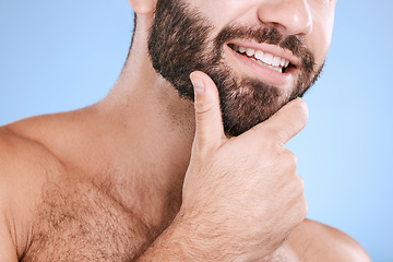 Image showing Skincare, beard and man with smile closeup in studio for grooming, hygiene and face cosmetic on blue background. Facial hair, male and model relax in luxury, beauty and routine, treatment or isolated