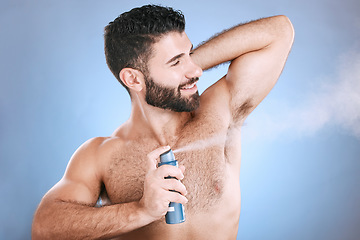 Image showing Deodorant, spray and man in studio for hygiene, fresh scent or underarm perfume. Male model spraying armpit for body odor, smell and cleaning cosmetics, shower product and skincare mist on background