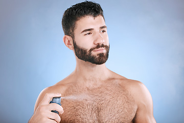 Image showing Deodorant, body spray and man in studio for hygiene, fresh scent and sweating perfume. Male model spraying odor cosmetics, fragrance and cleaning skincare of beauty mist, shower product or background