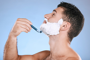 Image showing Shaving chin, foam and man with razor, beard maintenance and product placement in studio mock up. Shave cream, face and hair or skincare for male model facial grooming, isolated on blue background.