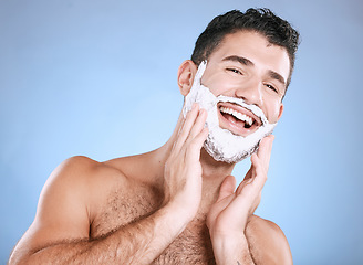 Image showing Facial, shaving cream on beard and man with smile, hands on face and product placement in studio mock up. Luxury shave foam, hair and skincare, happy male model grooming isolated on blue background.