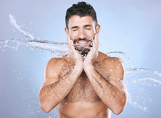 Image showing Man, water splash and face skin care for clean spa facial for beauty, hygiene and dermatology. Aesthetic model person blue background for health and wellness cosmetics, body glow and detox cleaning