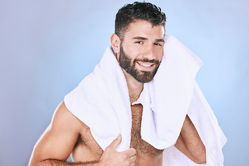 Image showing Man after shower with hygiene, towel and beauty in portrait, smile, face and grooming in studio. Skincare, cosmetics and cleaning body with healthy skin, mockup and cosmetic care on blue background