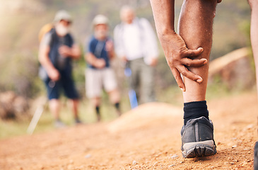 Image showing Injury, leg pain and hands of senior black man after hiking or sports accident outdoors. Training hike, elderly and male with fibromyalgia, inflammation or arthritis, broken bones or painful muscles.