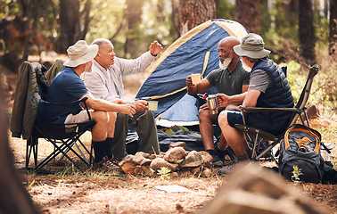 Image showing Man, friends and camping in nature with coffee for travel, adventure or summer getaway together on chairs in forest. Group of men relaxing, talking or enjoying natural camp out by trees in outdoors