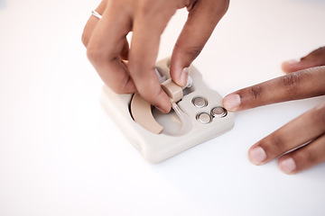 Image showing Disability, hand or black woman with deaf implant or device on office table in healthcare clinic. Medical, technology and girl doctor for medicine insurance, hearing aid or communication in hospital