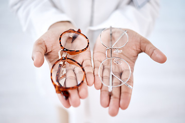 Image showing Optometry, vision and hands with glasses for choice, option and choosing medical product for eyes. Optometrist, healthcare and palms with frame, prescription lens and eyeglasses for sight correction