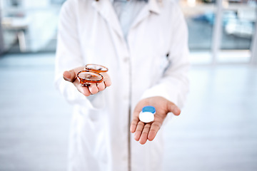 Image showing Eye care, choose glasses with contact lenses in hands, closeup and vision with healthcare for eyes. Prescription lens, person with frame choice and plastic container, optometrist and health