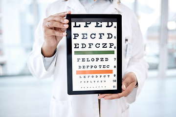 Image showing Hands, tablet screen and optometry chart in hospital for vision examination in clinic. Healthcare, snellen or woman, ophthalmologist or medical doctor holding technology showing letters for eye test.