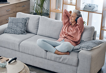 Image showing Happy, smile and headphones with old woman on sofa for music, wellness and streaming. Mobile radio, podcast and technology with lady listening in living room at home for health, relax and zen mindset