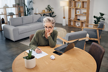 Image showing Focus, portrait and senior woman writing ideas for work from home budget, financial planning and laptop. Thinking, serious and boss, executive or entrepreneur with paperwork fail, taxes and finance