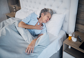 Image showing Heart attack, bedroom and senior woman with chest pain, sick and medical risk with medicine. Pills, stress or stoke of elderly person cardiology, breathing or lung problem with healthcare emergency