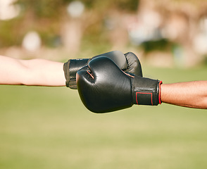 Image showing Team, boxing gloves and people fist bump in celebration, collaboration and teamwork in combat sports outdoors. Boxer, hands and friends or fighter training together as workout, exercise and fitness