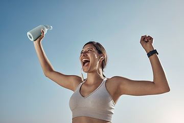 Image showing Fitness winner, workout and woman with drinking bottle for achievement outdoor. Excited, smile and athlete with blue sky feeling freedom from motivation and happiness with exercise target goal