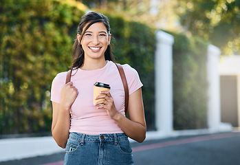 Image showing Travel, coffee and happy woman portrait by a city building with freedom on a urban in summer. Relax, smile and morning drink of a young person on vacation with happiness and backpack outdoor