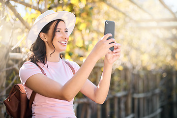 Image showing Phone, nature and woman taking a picture while on an outdoor holiday or weekend trip. Travel, freedom and happy young lady with a smile taking a photo of view on cellphone while on adventure vacation