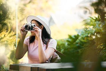 Image showing Photography, memory and woman with a camera in nature during travel in Singapore. Vacation, tourism and professional ecology photographer in a botanical garden to capture the natural environment