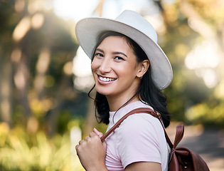 Image showing Woman smile, portrait and park walk of a young person happy about nature, travel and freedom. Happiness, backpack and laughing female with blurred background in a garden feeling relax and summer fun