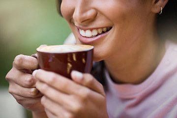 Image showing Happy, closeup and woman relax with coffee, content and satisfied on a blurred background. Smile, zoom and hands of girl with tea at outdoor cafe, peaceful and calm while enjoying off day or weekend